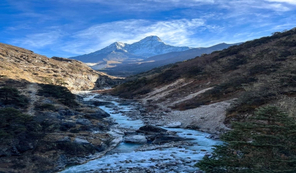 Glacial river flowing through a rocky alpine valley in the Nepal Himalayas